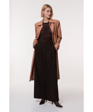 Feel elevated no matter the weather in our longline leather coat, made in high quality, sleek faux leather, featuring a relaxed fit that flatters the figure. The faux leather makes for a classic, traditional piece that maintains a heightened level of formality, especially paired with the structured shoulders. Wear it over any outfit, whether heading out for dinner or to the office. Faux Leather Clasp Detail Clean Tailored Trench Coat High Quality Faux Leather Fabric Flattering Straight Fit Pocket Features Formal, High Neckline Belted Waistline Button Front Fastening