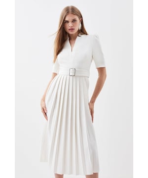 Meet the everlasting style icon - the Forever Dress. A timeless addition to any well-considered wardrobe, this petite piece features a high notched collar, V-neck front, a fit and flare silhouette, and a belted waist. Feel elevated in our midi dress, as the pleated skirt moves with you, and the structured shoulders bring the drama. Style it with heels or loafers for an elevated daytime look, perfect for year-round wear. Petite Tailored Structured Crepe Forever Pleat Midi Dress High Quality Crepe Fabric Textured, Pleated Skirt Unique Notched Neckline Wrap Style Bodice Statement Structured Shoulders Flattering Flared Skirt Belted Waistband Metallic Buckle Detailing Zip Fastening in Back Expertly designed for those 5'3" and under, our Petite pieces are perfectly proportioned for a smaller frame using shorter lengths.Browse this seasons petite tailored dresses or shop the full collection of women's petite clothing now.