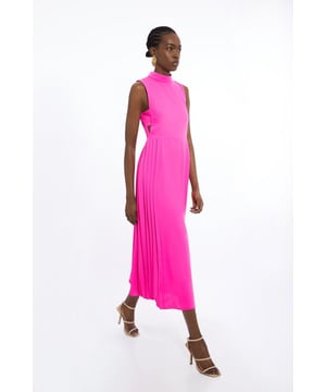 Feel elegant in our petite midaxi dress, with a universally flattering silhouette, a long skirt that creates flowing movement, and high neckline, perfect for getting a little dressed up. Style this dress with strappy heels for an outfit that will turn heads from wedding guest days to upcoming occasions and events. Petite Soft Tailored Pleated Panel Midaxi Dress Formal, Flowing Skirt Flattering Fit and Flare Silhouette High Neckline Bandeau Style Side Paneling Midi Length Button and Zip Fastening in Back Expertly designed for those 5'3" and under, our Petite pieces are perfectly proportioned for a smaller frame using shorter lengths.