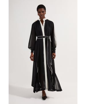 Embrace sophisticated style with this Karen Millen Military Mono Belted Woven Midi Dress. The contrasting white details on the sleeves and collar create a striking visual impact, while the belted waist allows for a personalised fit to flatter your figure. Perfect for daytime events, this dress can be styled for various casual occasions. Pair it with ankle boots and a leather jacket for a chic weekend brunch look, or dress it down with trainers and a denim jacket for a relaxed family gathering. The button-up crew neckline adds a touch of refinement, making it suitable for more polished daytime affairs. The side slits offer both practicality and style, ensuring comfort and ease of movement throughout your day. This versatile piece effortlessly transitions from day to night, making it a must-have addition to your wardrobe.  Striking contrast detailing on sleeves and collar Elegant midi length with a flowing silhouette Versatile belted waist for a customisable fit Button-up crew neckline for a polished look Side slits for ease of movement and added flair