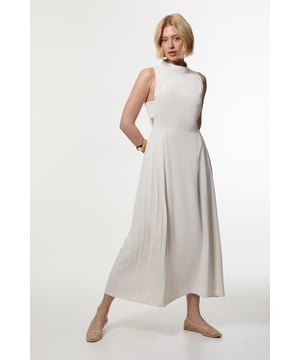 Feel elegant in our petite midaxi dress, with a universally flattering silhouette, a long skirt that creates flowing movement, and high neckline, perfect for getting a little dressed up. Style this dress with strappy heels for an outfit that will turn heads from wedding guest days to upcoming occasions and events. Petite Soft Tailored Pleated Panel Midaxi Dress Formal, Flowing Skirt Flattering Fit and Flare Silhouette High Neckline Bandeau Style Side Paneling Midi Length Button and Zip Fastening in Back Expertly designed for those 5'3" and under, our Petite pieces are perfectly proportioned for a smaller frame using shorter lengths.