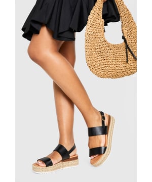 Chic double strap design for a contemporary twist on classic espadrilles
        Comfortable low heel height of 2.5-4.5cm perfect for all-day wear
        Adjustable ankle strap with buckle fastening for a secure fit
        Textured rope midsole adding authentic espadrille character
        Durable white sole providing additional grip and stability
    
    These double strap espadrilles from Boohoo blend comfort with effortless style for your summer wardrobe. The platform design creates a subtle lift while maintaining walkability, making them ideal for city breaks or beachside strolls. Style them with a flowing midi dress and oversized straw bag for daytime outings, or pair with cropped trousers and a relaxed blouse for casual family gatherings. The versatile silhouette works beautifully with both shorts and maxi skirts, offering endless styling possibilities throughout the warmer months. Their understated design ensures they'll complement both bold prints and minimalist outfits alike, while the secure ankle strap provides stability for those longer days on your feet. A true seasonal essential that combines practicality with Boohoo's signature contemporary flair.