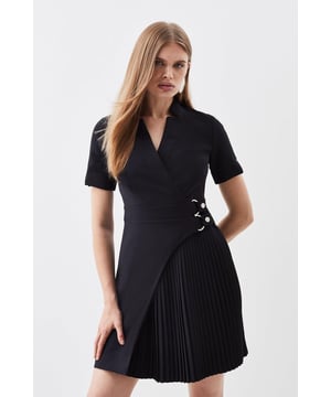 Feel elevated in our mini dress, with a high quality, tailored design that features a pleated panel and a universally flattering silhouette, as well as a notched neckline and a double belted waist. Style it with heels or loafers for an elevated daytime look, perfect for year-round wear. Tailored Military Pleat Notch Neck Wrap Mini Dress High Quality, Tailored Design Unique Pleated Panel Flattering Flared Fit Unique Notched Neckline Double Belted Waistband Metallic Buckle Detailing Zip Fastening in BackBrowse this seasons work dresses or discover the full range of workwear now.