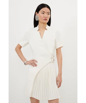 Feel elevated in our mini dress, with a high quality, tailored design that features a pleated panel and a universally flattering silhouette, as well as a notched neckline and a double belted waist. Style it with heels or loafers for an elevated daytime look, perfect for year-round wear. Tailored Military Pleat Notch Neck Wrap Mini Dress High Quality, Tailored Design Unique Pleated Panel Flattering Flared Fit Unique Notched Neckline Double Belted Waistband Metallic Buckle Detailing Zip Fastening in BackBrowse this seasons work dresses or discover the full range of workwear now.