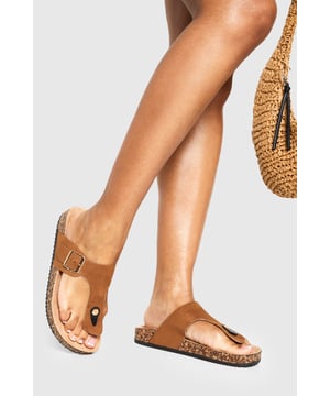 Trendy toe-post design for a classic summer look
        Adjustable buckle strap for a customised fit
        Comfortable cork-effect footbed for all-day wear
        Flat heel between 0 and 2cm for easy walking
        Versatile style suitable for various casual occasions
    
    Step into summer with these effortlessly chic slides from Boohoo. Perfect for the fashion-forward woman who values both style and comfort, these sandals are a must-have for your warm-weather wardrobe. The toe-post design adds a touch of classic appeal, while the adjustable buckle strap ensures a snug, personalised fit. Pair them with a flowing maxi dress and oversized sunglasses for a leisurely brunch date, or slip them on with denim shorts and a crop top for a casual day out shopping. The cork-effect footbed not only adds visual interest but also provides comfort for extended wear. Whether you're heading to a family barbecue or a casual catch-up with friends, these versatile slides will keep you looking stylish and feeling comfortable all day long.