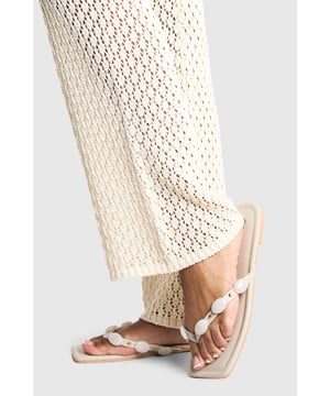Elegant flat sandals featuring decorative pearl embellishments for a touch of sophistication
        Comfortable flat heel measuring between 0-2cm, perfect for all-day wear
        Toe-post design with a delicate strap adorned with pearl details
        Sleek square toe silhouette for a contemporary finish
        Crafted from durable PU material with a smooth finish for lasting style
    
    These charming pearl-detailed sandals strike the perfect balance between casual comfort and refined style. The minimalist design makes them incredibly versatile for your summer wardrobe, whilst the decorative pearl embellishments add a feminine touch to the simplest of outfits. Style them with flowing maxi dresses and crochet separates for relaxed daytime occasions, or pair with cropped linen trousers and a crisp blouse for casual family gatherings. The flat heel ensures comfort for long summer days exploring the city or seaside strolls, whilst the neutral palette allows for effortless coordination with your existing wardrobe. These sandals embody Boohoo's commitment to accessible fashion that doesn't compromise on style, making them an essential addition to your summer footwear collection.