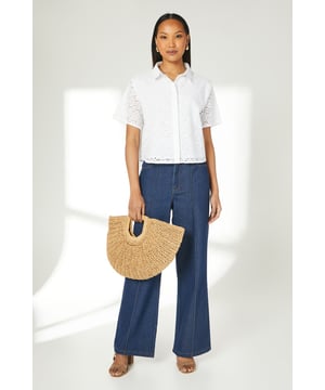 Intricate broderie anglaise pattern throughout
        Collared neckline for a polished look
        Short sleeves with scalloped edges
        Boxy fit for a relaxed silhouette
        Button-down front closure
    
    This charming broderie cotton T-shirt from Principles is a versatile addition to your warm-weather wardrobe. The delicate eyelet detailing adds a touch of femininity, while the boxy fit ensures comfort for all-day wear. Style it with wide-leg trousers and sandals for a chic daytime look perfect for brunches or casual outings. For a more laid-back ensemble, pair it with your favourite denim shorts and trainers for a weekend stroll. The collared neckline allows for easy accessorising - add a dainty necklace to draw attention to the dcolletage. This T-shirt is ideal for various casual events, from family gatherings to shopping trips with friends. Its breathable cotton fabric makes it a go-to choice for balmy summer days, keeping you cool and stylish.