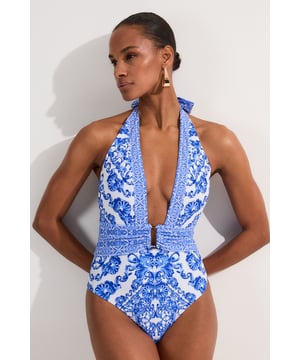 Make a splash in this eye-catching scarf print swimsuit from Karen Millen. The intricate pattern radiates sophistication, whilst the plunging neckline and high-cut leg create a sultry silhouette. Perfect for lounging by the pool or strolling along sun-drenched beaches, this swimsuit combines style with practicality. Pair with oversized sunglasses and a wide-brimmed hat for ultimate poolside glamour. For a stylish beach-to-bar look, throw on a sheer kaftan and wedge sandals. The halterneck tie allows for a customised fit, ensuring comfort throughout your sun-soaked adventures. Whether you're jetting off to a tropical paradise or enjoying a staycation, this swimsuit will have you feeling confident and fabulous.  Striking scarf print design for a luxurious look Plunging neckline adds a touch of allure Halterneck style with tie fastening for adjustable fit Figure-flattering cut with defined waistband High-cut leg elongates the silhouette