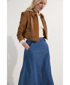This Karen Millen denim midi skirt is a versatile wardrobe staple that effortlessly bridges the gap between casual and smart-casual attire. The full, flared silhouette creates a graceful movement as you walk, while the high-waisted design accentuates your natural curves. Style it with a fitted knit top and ankle boots for a stylish daytime look, perfect for weekend brunches or casual family gatherings. For a more relaxed vibe, pair it with a simple t-shirt and trainers. The side pockets add a practical touch, ideal for keeping small essentials close at hand. This skirt's adaptable nature makes it suitable for various occasions, from laid-back office days to informal evening outings. Its timeless design ensures it will remain a go-to piece in your wardrobe for seasons to come.  Midi-length denim skirt with a full, flared silhouette High-waisted design for a flattering fit Side pockets for practicality and style Versatile cotton fabric suitable for various seasons Subtle A-line shape creates a feminine profile