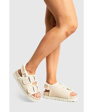 Trendy boucle fabric for a textured look
        Wide fit design for enhanced comfort
        Double adjustable straps with buckle closures
        Flat sole with a height between 0 and 2cm
        Chunky, textured outsole for improved grip
    
    Step into comfort and style with these on-trend dad sandals from Boohoo. The boucle fabric adds a unique textural element, while the wide fit ensures all-day wearability. Perfect for the fashion-forward woman who values both comfort and aesthetics, these sandals are versatile enough for various casual occasions. Pair them with cropped wide-leg trousers and an oversized linen shirt for a chic brunch look, or style them with a floaty midi dress for a relaxed garden party ensemble. The adjustable straps allow for a customised fit, making these sandals ideal for long walks or casual family gatherings. Their chunky sole not only provides a trendy silhouette but also offers practical grip for various surfaces. Embrace the 'ugly-chic' trend with these sandals that seamlessly blend comfort with contemporary fashion sensibilities.