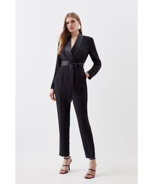 Feel elevated in our jumpsuit, with a fit that flatters the figure, featuring a wrap style and a wide belt at the waist to create a head turning silhouette, as well as a straight leg fit. Style it with court heels or strappy stilettos for a look ideal for anything from office days to dinner dates. Tailored Tuxedo Wrap Jumpsuit High Quality, Tailored Design Universally Flattering Wrap Style Wide Belt Feature V Neckline Comfortable Straight Leg Fit Tie Side FasteningDiscover our collection of occasion wear or browse our range of women's occasion dresses now.