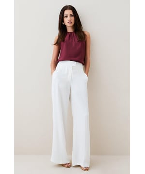 Colliding the scintillating quality of satin with the sharp lines of tailoring, these trousers present an artful balance. Languid over the form, they flow with unparalleled movement.High waistbandInverted pleatsLong wide legsExpertly designed for those 5'3" and under, our Petite pieces are perfectly proportioned for a smaller frame using shorter lengths.Style: Wide Leg TrousersFabric: WovenLength: RegularBrowse this seasons women's petite trousers or shop the full collection of women's petite clothing now.