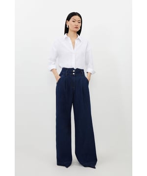 Bring in the summer with a pair of our petite wide leg trousers, made in denim fabric, with a dramatic, wide fit. The minimal design makes them easy to style, so wear them with a cropped T-shirt and trainers on a casual day, then a button up shirt and loafers for a more elevated approach. Petite Denim Indigo Wide Leg Trousers High Quality Denim Fabric Comfortable High Waistline Unique Notched Waistband Flattering Wide Leg Fit Expertly designed for those 5'3" and under, our Petite pieces are perfectly proportioned for a smaller frame using shorter lengths.Browse this seasons women's petite workwear or shop the full collection of women's petite clothing now.