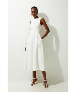 Experience everyday elegance in our midi dress, made with summer ready linen fabric, with a fit and flare silhouette and tab details designed to cinch the waist. Style it with sandals or court heels for a look that will take you from summer office days to date nights. Premium Linen Tab Waist Detail Full Skirt Tailored Midi Dress High Quality Linen Fabric Flattering Fitted Bodice Dramatic Flared Skirt Unique Tab Accents on Waist Pocket Detailing Sleeveless Design Zip Fastening in Back