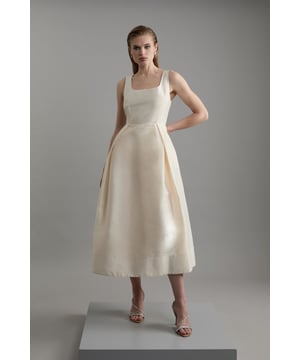 Defined by effortless elegance and timeless sophistication, the new By Lydia: Summer '24 collection captures Lydia Millen's signature style. Feel elegant in our midi dress, with a universally flattering silhouette, a long skirt that creates flowing movement, and a square neckline, perfect for introducing some old-school glamour to your wardrobe. Style this dress with strappy heels for an outfit that will turn heads from wedding guest days to upcoming occasions and events. Lydia Millen Taffeta Full Skirt Tailored Midi Dress High Quality Taffeta Fabric Formal, Flowing Skirt Flattering Fit and Flare Silhouette Square Neckline Comfortable, Wide Shoulder Straps Midi Length Zip Fastening in BackBrowse this seasons work dresses or discover the full range of workwear now.