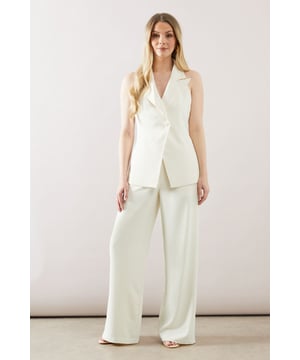 Sleek longline waistcoat with a sophisticated collar
        Halterneck design for a modern, chic look
        Wide-leg trousers with a flattering high waist
        Side pockets for practicality and style
        Back split detail on trousers for ease of movement
    
    This collared longline waistcoat ensemble from Wallis is the epitome of contemporary sophistication. Perfect for the woman who appreciates glamour with a comfortable edge, this set is versatile enough for various occasions. The sleek waistcoat, featuring a halterneck design, pairs beautifully with the wide-leg trousers, creating a flowing silhouette that's both flattering and on-trend. For a casual yet polished look, style with minimalist jewellery and strappy sandals. When attending family gatherings or informal events, layer with a lightweight blouse underneath for added dimension. The ensemble's clean lines and elegant simplicity make it an ideal choice for those seeking a refined appearance without sacrificing comfort. Customise the look with a statement belt to define the waist or leave it open for a more relaxed feel. This Wallis piece promises to be a versatile addition to your wardrobe, ready to take you from day to night with effortless grace.