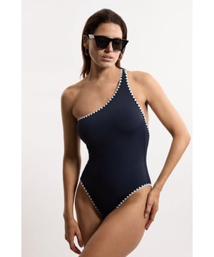 Welcome the sun with a swimsuit that will turn heads, featuring a statement one shoulder design, contrasting stitch details, and a low back. Style this piece with strappy sandals and a beach cover up for a holiday look that can be reworn time and time again. Stitch Detail One Shoulder Cut Out Swimsuit Contrasting Stitch Accents Flattering One Shoulder Design Statement Open Back