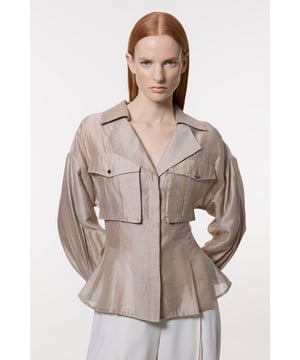 Distinctive organdie slub texture for a unique look and feel Utility-inspired design with prominent chest pockets Voluminous balloon sleeves for a dramatic silhouette Collared neckline adds a touch of sophistication Cinched waist creates a flattering feminine shape  This Karen Millen blouse masterfully blends utility chic with feminine flair. The organdie slub fabric lends a captivating texture, while the prominent chest pockets nod to practical workwear. The voluminous balloon sleeves create a striking contrast to the fitted waist, resulting in a beautifully balanced silhouette. Perfect for elevating your daywear wardrobe, this versatile piece can be styled for various casual occasions. Pair it with tailored trousers and loafers for a smart lunch date, or dress it down with your favourite denim and trainers for a stylish weekend look. The neutral hue ensures easy coordination with your existing wardrobe, making this blouse a go-to choice for effortless, polished style.