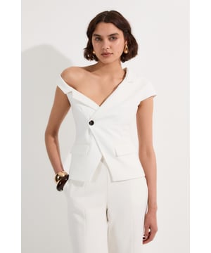Make a bold statement in the office with this Clean Tailored Asymmetric Collar Belted Tailored Top from Karen Millen. The unique asymmetric collar adds a contemporary edge to this classic workwear piece, whilst the belted waist creates a flattering silhouette. Perfect for those who want to stand out whilst maintaining a professional appearance, this top can be styled with tailored trousers and court shoes for a refined look. For a more relaxed ensemble, pair it with wide-leg trousers and loafers. The versatility of this piece allows for seamless transition from day to evening, making it an essential addition to your workwear wardrobe. Its clean lines and structured design convey confidence and sophistication, ensuring you're always dressed to impress in any professional setting.  Striking asymmetric collar design for a modern twist Tailored silhouette with a belted waist for a flattering fit Single button closure for a sleek and polished look Cap sleeves offer a sophisticated touch Versatile piece suitable for various professional settings