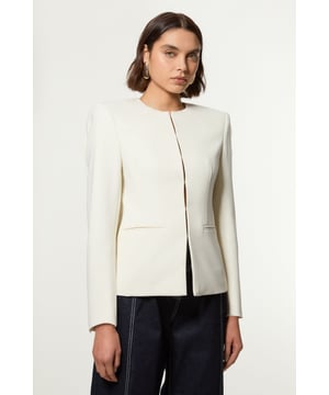 This Karen Millen blazer showcases a refined blend of style and comfort, perfect for the modern British woman. The tailored seam detailing creates a flattering shape, while the collarless design offers a contemporary twist on a classic piece. Pair it with your favourite jeans and a crisp white tee for a smart casual ensemble ideal for brunch with friends or a day at the office. For a more dressed-up look, team it with tailored trousers and heeled boots. The versatile nature of this blazer makes it a wardrobe staple, easily transitioning from daytime meetings to evening drinks. Its stretch fabric ensures comfort throughout the day, allowing you to move with ease while maintaining a polished appearance.   Tailored seam detailing for a structured silhouette Collarless design with a round neckline Sleek front closure for a polished look Functional front pockets add practicality Versatile regular fit suitable for various body types