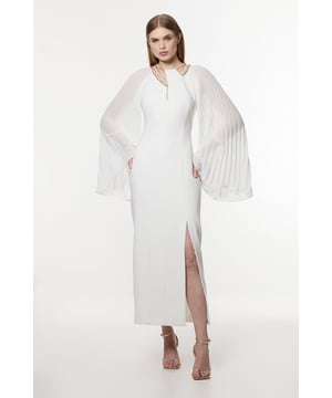 Experience elevated occasion wear in our maxi dress. The silhouette skims the figure and flaunts the curves, while the pleated sleeves all coverage and enchanting detail. The metallic chains add dimension, while the leg split not only breaks the dress up, but allows for easy movement. Style it with strappy heels for a statement evening look. Enamel Chain Detail Kimono Maxi Dress Striking Metallic Chain Detailing Statement Kimono Sleeves High Neckline Thigh High Leg Split Figure Hugging Silhouette Button and Zip Fastening in BackDiscover our collection of occasion dresses or browse our range of women's occasion wear now.