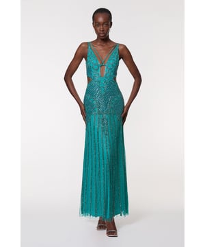 This Karen Millen Crystal Embellished Strappy Maxi Dress is a showstopping choice for your most prestigious events. The intricate crystal embellishments and beadwork create a mesmerising pattern that catches the light with every movement, ensuring all eyes are on you. Featuring a plunging neckline and cut-outs, this figure-hugging silhouette flows into a dramatic maxi length, perfect for making a grand entrance. Style this dress with sleek, strappy heels and minimal jewellery to let the dress take centre stage. Ideal for black-tie galas, awards ceremonies, or as a show-stopping wedding guest outfit, this dress promises to make you feel like the belle of the ball. Remember to handle with care due to the delicate embellishments, and consider a wrap or shawl for cooler evenings.  Stunning crystal embellishments create an intricate, eye-catching pattern Plunging neckline with strappy detailing for a daring look Figure-hugging silhouette that flares into a dramatic maxi length Strategic cut-out details at the waist add allure and interest Delicate beadwork and sequins catch the light for a glamorous effect