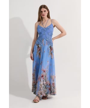 Intricate floral applique lace bodice Sweetheart neckline with delicate straps Pleated maxi skirt with floral print Criss-cross back detail Floor-length design for a dramatic silhouette  This Karen Millen maxi dress combines romantic elegance with modern flair. The bodice features exquisite floral applique lace, creating a textured, three-dimensional effect that catches the light beautifully. The sweetheart neckline and thin straps offer a feminine touch, while the criss-cross back adds a contemporary twist. The pleated maxi skirt flows gracefully from the waist, adorned with a stunning floral print that complements the lace detailing. Perfect for summer weddings, garden parties, or formal events, this dress can be styled with strappy heels and delicate jewellery for a sophisticated look. For cooler evenings, drape a lightweight shawl over your shoulders. The versatile design allows for both daytime elegance and evening glamour, making it a standout piece in your occasion wear collection.