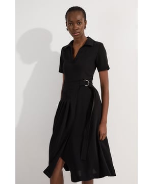 This Karen Millen soft tailored midi dress strikes the perfect balance between professional polish and feminine charm. The classic collared design and pleated detailing create a sophisticated silhouette that commands attention in any boardroom or office setting. Style with pointed court shoes and a structured tote for daytime meetings, or transition to evening networking events with statement earrings and a sleek clutch. The belted waist offers customisable definition, whilst the midi length ensures appropriate coverage for formal workplace settings. This versatile piece works beautifully layered under a tailored blazer during cooler months or worn alone when temperatures rise. A timeless addition to your workwear rotation that delivers effortless elegance with practical comfort.  Elegant collared neckline with a sophisticated V-opening for a refined workwear silhouette Short sleeves offering comfortable coverage whilst maintaining a professional appearance Stylish D-ring belt detail that cinches the waist for a flattering, feminine shape Graceful pleated skirt with a flowing midi length that creates elegant movement Practical side pockets discreetly integrated into the design for functionality