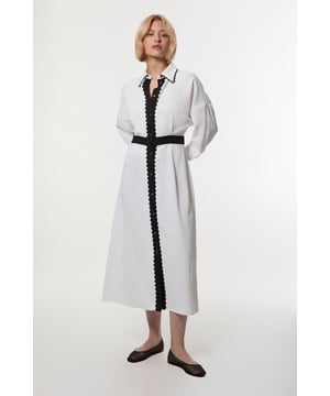 Feel confident in our shirt dress, with a fit that cinches in at the waist, a long, flowing skirt, and charmin scalloped detailing. Style it with court heels or ankle boots for a look perfect for office days, then wear it with heeled boots or stilettos for an evening look. Scallop Trim Woven Crepe Shirt Dress High Quality Crepe Fabrict Flattering Relaxed Fit Formal Collar Accent Unique Scalloped Detailing Button Front Fastenings Long Sleeves