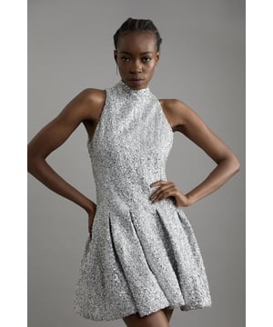 Experience elevated occasion wear in our tailored mini dress, with statement sequin fabric, and a playful. full skirt. Pair this piece with strappy heels for an outfit perfect for party nights and formal occasions. Tall Sequin Metallic Boucle Halter Full Skirt Tailored Mini Dress High Quality , Sparkling Sequin Fabric High, Round Neckline Mini Length Sleeveless Design Dramatic, Skater Silhouette Full, Ruffled Skirt Button Fastening in Back Expertly designed for those 5'10" and above, our Tall pieces are perfectly proportioned for a taller frame using longer lengths.