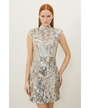 Emanante confidence in our petite mini dress, with statement embellished detailing, and a figure hugging silhouette accentuated by a cut out in the back. Pair it with heels for a look that will see you from date nights to party nights. Petite Embellished Pearl Strong Shoulder Mini Dress High Quality Embellished Detailing Flattering Fitted Silhouette High Neckline Structured Shoulder Feature Cut Out Back Design Hook and Eye and Zip Fastening in Back Expertly designed for those 5'3" and under, our Petite pieces are perfectly proportioned for a smaller frame using shorter lengths.