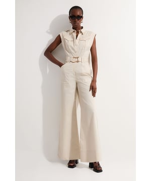 Sleeveless utility-inspired jumpsuit with collared neckline Wide-leg silhouette for a relaxed and comfortable fit Prominent gold hardware accents, including a statement belt buckle Multiple functional pockets for added practicality Distinctive top-stitch detailing for a refined finish  This Karen Millen cotton sateen jumpsuit radiates effortless chic with its utility-inspired design. The wide-leg cut offers both comfort and style, making it perfect for various daytime occasions. Style it with flat sandals and oversized sunglasses for a casual brunch with friends, or dress it up with wedges and statement earrings for a family gathering. The gold hardware adds a touch of sophistication, while the multiple pockets ensure practicality. For a more structured look, cinch the waist with the included belt. Layer with a lightweight cardigan for cooler days or wear it on its own for a sleek summer ensemble. This versatile piece can easily transition from a day of shopping to an evening outdoor concert, making it a must-have addition to your wardrobe.