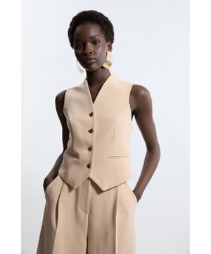 Elevate your top selection with our waistcoat, with a figure hugging fit, and buttons down the front. This piece pairs well with anything, from matching separates, to tailored trousers, to jeans for an elevated look that will take you seamlessly from day to night. Essential Tailored Button Through Waistcoat Classic Waistcoat Style V Neckline Fitted Silhouette Sleek, Minimal Design Button Front Fastening Matching Trousers Sold Separately