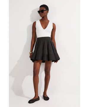 Tailored cotton mini skirt with a full, flared silhouette High-waisted design for a flattering fit Structured pleats add volume and movement Versatile length suitable for various occasions Smooth waistband for a sleek finish  This Karen Millen tailored cotton mini skirt is a versatile wardrobe staple that combines comfort with style. The full, flared silhouette creates a feminine shape, while the high-waisted design accentuates your curves. Perfect for daywear, this skirt can be styled for various casual events. Pair it with a fitted bodysuit and ballet flats for a chic look at family gatherings. For a more relaxed vibe, team it with a loose-fitting t-shirt and trainers. The structured pleats add a touch of sophistication, making it suitable for brunch dates or shopping trips with friends. The cotton fabric ensures breathability, ideal for warm weather outings. Accessorise with a woven tote and oversized sunglasses to complete your effortlessly stylish ensemble.