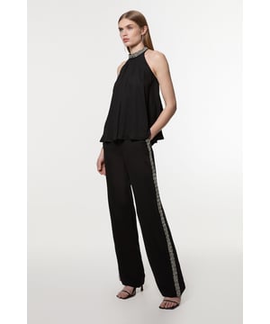 Experience sleek tailoring in a pair of straight leg trousers, with a flattering, relaxed fit and a comfortable high waistline. The sparkling embellishments are hand placed and make for a striking occasion look. Style it with the matching top for a co-ordinating look, or with a blazer and boots for a more laid back approach. Hand Embellished Cady Woven Trouser High Quality Tailored Design Comfortable High Waistline Flattering Straight Leg Fit Sparkling Hand Embellished Strip Down Sides Pocket Accents Matching Top Sold SeparatelyDiscover our collection of occasion wear or browse our range of women's occasion dresses now.