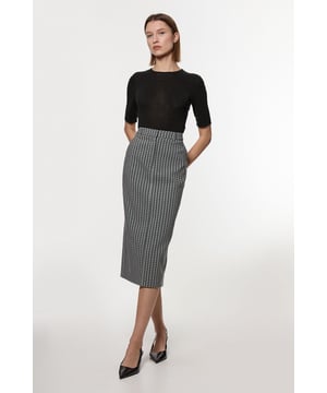 Experience updated wardrobe essentials with our midi skirt, with a straight silhouette and a high waistline, creating a universally flattering fit. The geometric print adds immediate intrigue, elevating this piece beyond a basic. Style this piece with anything, from the matching jacket and strappy heels, to a knit jumper, tights, and boots. Jacquard Tailored Midi Pencil Skirt High Quality Jacquard Fabric Sleek, Minimal Design Comfortable High Waistline Flattering Figure Hugging Silhouette Unique Geometric Print Matching Jacket Sold Separately