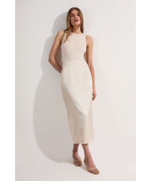 Embrace refined elegance with this tailored column midi skirt from Karen Millen. The streamlined silhouette creates a polished look suitable for a variety of formal occasions. Style it with a crisp white blouse and pointed-toe heels for a chic office ensemble, or pair it with a silk camisole and strappy sandals for summer weddings. The versatile midi length allows for effortless transition from day to evening events. For a coordinated outfit, team it with the matching blazer as seen on the model. The linen-blend fabric offers a luxurious feel while ensuring breathability, making it an ideal choice for warm-weather formal gatherings. Accessorise with minimalist jewellery to maintain the skirt's sleek aesthetic, allowing its impeccable tailoring to take centre stage.   Tailored column silhouette for a sleek, sophisticated look Midi length hitting below the knee for versatile styling High-waisted design to accentuate the waistline Subtle back slit for ease of movement Crafted from a linen-blend fabric for breathable comfort
