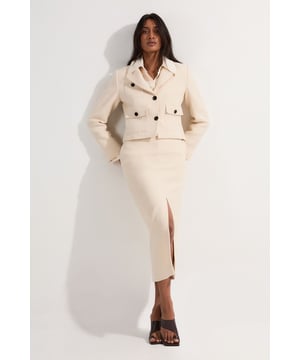 This Karen Millen Textured Tweed Tailored Pencil Skirt is a versatile wardrobe staple that effortlessly transitions from day to night. The timeless tweed fabric adds texture and interest, while the tailored pencil shape creates a sleek silhouette. Style it for a casual daytime look by pairing it with a crisp white shirt and flat sandals, as seen on the model. For family gatherings or lunch with friends, team it with a soft knit jumper and ankle boots. The front slit allows for comfortable movement, making it ideal for various casual events. The functional side pockets add practicality, while the belt loops offer the option to customise your look with different belts. This skirt's classic design ensures it will remain a go-to piece in your wardrobe for seasons to come, perfect for creating polished yet relaxed outfits for a range of casual occasions.  Textured tweed fabric for a classic, sophisticated look Tailored pencil silhouette for a flattering fit Front slit detail for ease of movement Functional side pockets with button closure Slim belt loops for versatile styling options