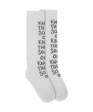 77% cotton, 20% polyamide, 3% elastane. Raeyâ€™s white socks feature a black jacquard slogan that reads â€˜knock their socks offâ€™ for a playful tone. Theyâ€™re made in Italy from a soft cotton-blend with textural ribbing