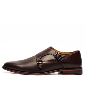The Red Tape Monk Strap Shoe, embodies timeless sophistication and refined style, making it an essential addition to any modern gentleman's wardrobe. Crafted in a traditional monk style, these shoes feature premium leather construction, ensuring exceptional durability and a polished, classic appearance. Designed in a rich brown hue, this double monk strap showcases a rounded toe that adds a touch of classic refinement, effortlessly elevating any outfit.
 The adjustable double buckle fastening not only enhances the shoes distinctive character but also provides a secure, customized fit for maximum comfort. Perfect for both formal occasions and smart-casual ensembles, these shoes can be paired with tailored trousers for a sophisticated look or worn with jeans and a relaxed shirt for a polished off-duty style.
 Inside, the lining ensures all-day comfort, making these shoes as practical as they are stylish. The impeccable craftsmanship and premium materials guarantee long-lasting wear and timeless appeal. Seamlessly blending classic with contemporary elegance, the Red Tape Monk Strap Shoe is the perfect finishing touch to any formal or smart-casual outfit, allowing you to make a sophisticated statement with ease.

 - Premium Leather upper
 - Adjustable double buckle fastening
 - Stacked effect midsole
 - High end looks
 - Designer stitch detailing
 - Durable outsole
 - Red Tape branding
 Please Note: Red Tape manufacturer for many well-known high street stores and we believe these shoes may have been destined for one of them as they will come to you delivered in a plain white presentation box.