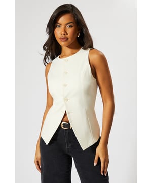 Sleek high neck design for a sophisticated look
        Tailored fit accentuates the waistline
        Unique button-front closure adds visual interest
        Versatile sleeveless style perfect for layering
        Asymmetrical hem creates a modern silhouette
    
    Make a bold statement with this tailored high neck waistcoat from MissPap. This eye-catching piece combines classic tailoring with contemporary flair, perfect for the fashion-forward woman who loves to stand out. The sleek high neck and button-front closure create a polished look, while the asymmetrical hem adds a touch of edginess. Style it with wide-leg trousers and strappy heels for a chic evening ensemble, or layer it over a crisp white shirt and pair with jeans for a smart-casual daytime look. The versatile design makes it ideal for various occasions, from casual gatherings to nights out on the town. This waistcoat is a must-have addition to any wardrobe, offering endless styling possibilities and ensuring you'll always be the centre of attention.