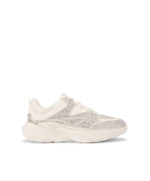 This Livy sneaker is crafted from a bone fabric which is embellished with gold crystals. The front laces up with mesh panels.