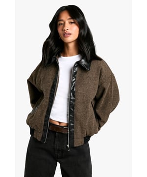Petite-friendly bomber jacket with wool-look texture for added warmth
        Striking contrast PU collar and trim detailing for a contemporary edge
        Relaxed, oversized silhouette with dropped shoulders for effortless styling
        Full-length front zip fastening for versatile wear options
        Ribbed hem and cuffs for a snug, comfortable fit
    
    Make a statement in this fashion-forward bomber jacket that combines classic styling with modern details. The wool-look texture creates a cosy feel whilst the contrasting PU trim adds an urban edge that's perfect for the fashion-conscious. The relaxed fit allows for easy layering over your favourite basics - pair with a simple white crop top and black jeans as seen on our model for an effortlessly cool daytime look. This versatile piece works brilliantly for casual coffee dates, weekend shopping trips or evening drinks with friends. For a more polished ensemble, layer over a fine knit jumper with tailored trousers and ankle boots. The petite cut ensures the proportions are just right, eliminating the need for alterations. A true wardrobe hero that will see you through the seasons with its adaptable styling potential.