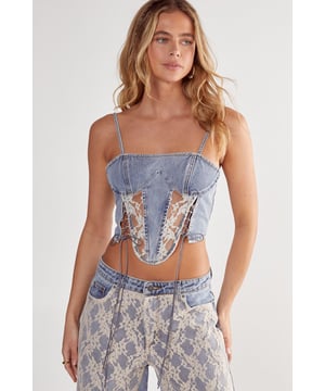 Structured denim corset top with delicate lace panel inserts
        Adjustable thin straps for a customised fit
        Side lace-up detailing with contrasting ribbon ties
        Structured bust with defined centre panel
        Cropped length perfect for layering or statement wear
    
    Make a bold statement with this NastyGal denim corset top featuring intricate lace detailing. The structured silhouette creates a flattering shape whilst the contrasting lace panels add a touch of feminine allure to the edgy denim fabric. As seen on our model, pair with matching wide-leg trousers featuring complementary lace detailing for a coordinated ensemble that commands attention. This versatile piece transitions effortlessly from casual daytime styling with high-waisted jeans and trainers to evening glamour when matched with statement trousers and heels. The adjustable straps and side lace-up feature allow for a personalised fit that moulds to your shape. Perfect for nights out at the club, drinks with friends or any occasion where you want to showcase your distinctive style with confidence.
