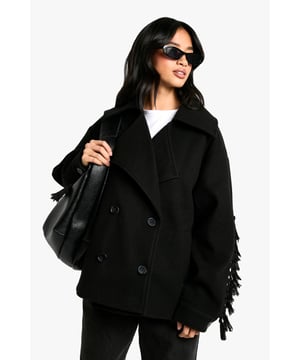 Striking fringe detail along the back and sleeves for a distinctive western-inspired look
        Oversized silhouette with dropped shoulders offering a relaxed, contemporary fit
        Double-breasted button fastening for added warmth and classic styling
        Wide lapel collar creating a sophisticated frame for layering options
        Petite-friendly proportions designed specifically for smaller frames
    
    Make a statement in this eye-catching wool-look mantel coat with its standout fringe detailing. The relaxed, oversized cut creates a fashion-forward silhouette that works brilliantly with both casual and dressed-up outfits. Style as seen with wide-leg trousers and a simple white tee for an effortlessly cool daytime look, or layer over a midi dress with trainers for weekend brunches. The versatile design transitions seamlessly from family gatherings to coffee dates with friends. For chillier days, add a chunky knit scarf and leather gloves. This Boohoo piece captures the latest trends whilst maintaining everyday wearability - the perfect addition to your autumn-winter wardrobe that will turn heads for all the right reasons.
