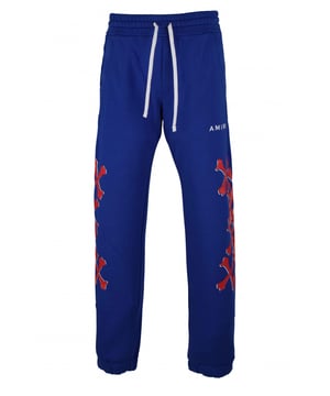 Amiri joggingbroek van blauw katoen.Witte logoprint op de voorkant.Rode botprints langs de pijpen.Elastische tailleband met trekkoorden.Elastische enkels.Zijzakken.Eén achterzak.Zwarte logopatch op de achterkant.Gemaakt in Italië.