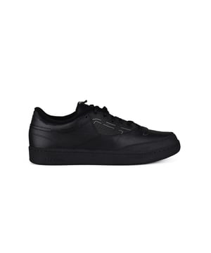 Club C Reebook Maison Margiela Sneakers in Schwarz.Aus Leder gefertigt.Details mit Steppnähten.Verschluss mit Schnürsenkeln.Außensohle aus Gummi.