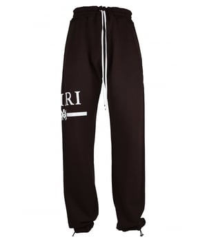 Pantalón de chándal Amiri de algodón marrón.Logotipo blanco estampado en una pernera.Cintura elástica con cordones blancos.Bolsillos laterales.Un bolsillo trasero.Tobillos elásticos con cordones.Made in Italy.