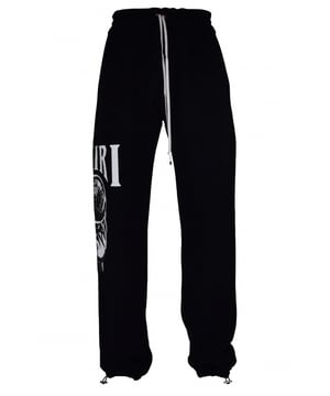 Pantalón jogging Amiri de algodón negro.Estampado gráfico Crystal Ball blanco en una pernera.Cintura elástica con cordones blancos.Logotipo negro en la parte trasera.Bolsillos laterales.Un bolsillo trasero.Tobillos elásticos con cordones.Made in Italy.
