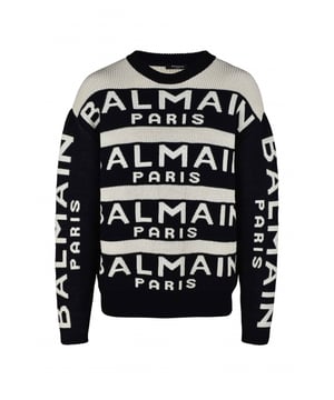 Jersey de lana blanco y negro de Balmain.Rayas negras con logotipo blanco.Mangas largas negras con logotipo blanco.Cuello redondo.Bordes de canalé.64% lana y 36% poliamida.Made in Italy.